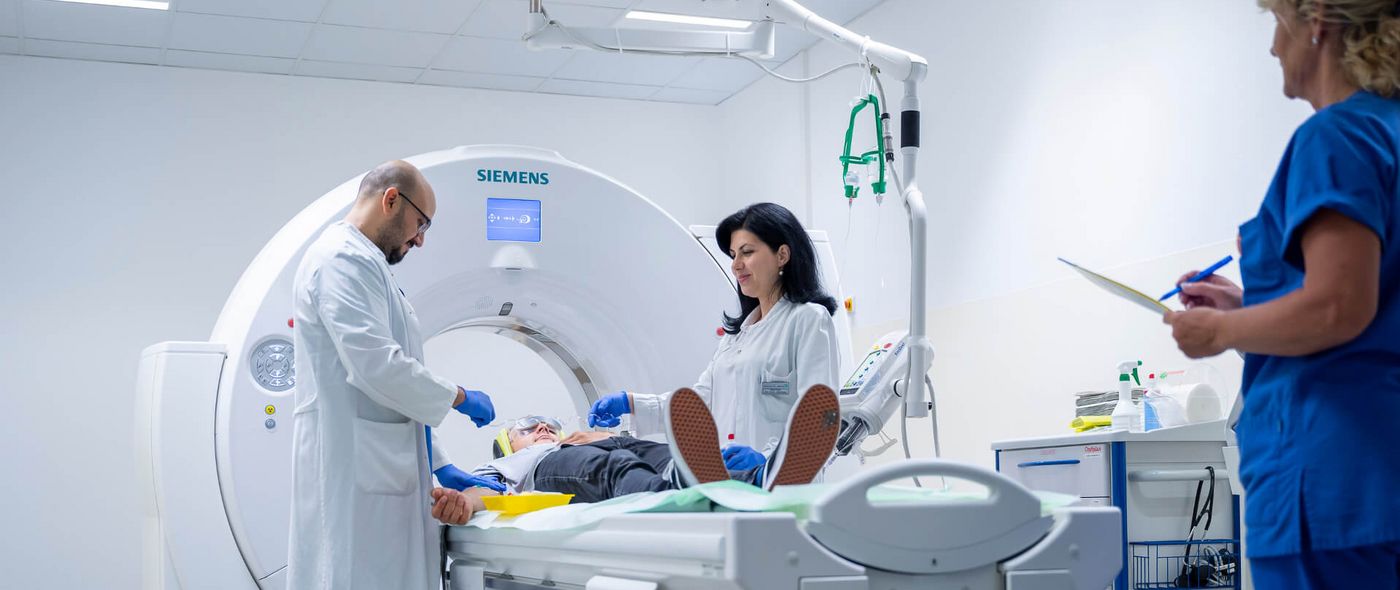 Arzt und Pflegekraft bereiten Patienten auf CT-Scan vor